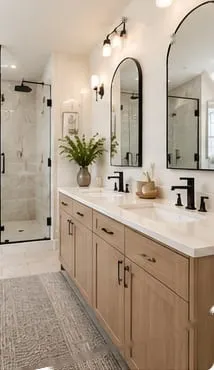 Primary bathroom after: custom shower and a wood double vanity with arched mirrors