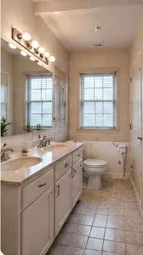 Primary bathroom before: dated double vanity and tile floor